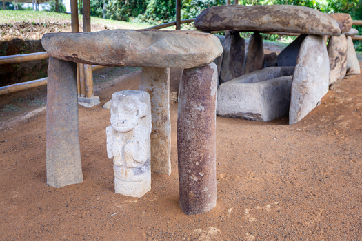 View of ancient stone statue and megalithic tomb structure at San Agustin Archaeological Park in San Agustin Huila Colombia.