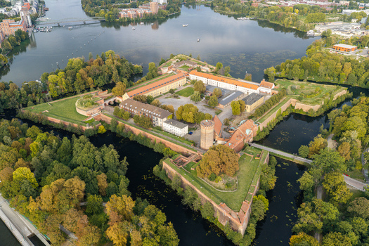 Aerial view of Spandau Citadel surrounded by historic fortifications lush greenery and the Havel river in Berlin Berlin Germany.