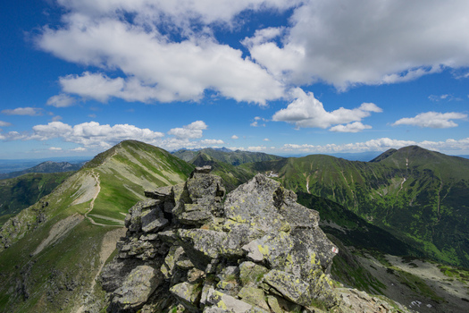 View of Tri kopy in Western Tatras with sharp rocky peaks and green mountain slopes under a blue sky with white clouds in Ziar Zilina Region Slovakia. View of Tri kopy in Western Tatras with sharp rocky peaks and green mountain slopes under a blue sky with white clouds in Ziar Zilina Region Slovakia.
