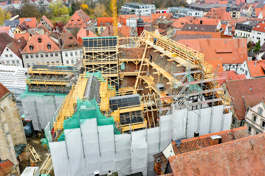 Aerial view of Rathaus Forchheim under renovation with extensive scaffolding and wooden structures among historic red tiled rooftops Forchheim Bayern Germany. Aerial view of Rathaus Forchheim under renovation with extensive scaffolding and wooden structures among historic red tiled rooftops Forchheim Bayern Germany.