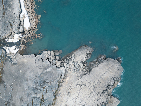Svalbard and Jan Mayen 28 July 2025 Aerial view of the rugged rocky coastline with fractured stone formations and turquoise arctic waters. Svalbard and Jan Mayen 28 July 2025 Aerial view of the rugged rocky coastline with fractured stone formations and turquoise arctic waters.