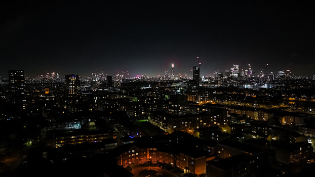 Aerial view of the London skyline at night featuring illuminated skyscrapers residential buildings and city lights glowing against the dark sky in London England United Kingdom. Aerial view of the London skyline at night featuring illuminated skyscrapers residential buildings and city lights glowing against the dark sky in London England United Kingdom.