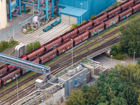 Aerial view of the Heizkraftwerk Reuter West power plant featuring freight trains on railway tracks and industrial infrastructure in Berlin Berlin Germany.