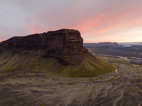 Aerial view of Skaftafellsjökull glacier meeting the rugged moss covered landscape under a pastel dawn sky Skaftafell Skaftárhreppur Iceland. Aerial view of Skaftafellsjökull glacier meeting the rugged moss covered landscape under a pastel dawn sky Skaftafell Skaftárhreppur Iceland.