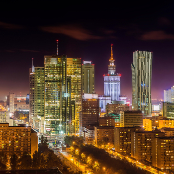 Aerial view of the illuminated Warsaw skyline at night featuring the Palace of Culture and Science and modern skyscrapers in Warsaw Masovian Voivodeship Poland. Aerial view of the illuminated Warsaw skyline at night featuring the Palace of Culture and Science and modern skyscrapers in Warsaw Masovian Voivodeship Poland.