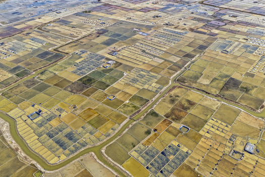 Aerial view of the patchwork of salt farms meeting the sky creating a mesmerizing mosaic of earth tones Cox s Bazar Chittagong Division Bangladesh. Aerial view of the patchwork of salt farms meeting the sky creating a mesmerizing mosaic of earth tones Cox s Bazar Chittagong Division Bangladesh.