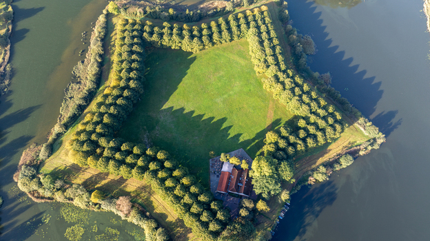 Aerial view of Pettelaarse Schans a star shaped historic fortification surrounded by a moat and lush green trees in s Hertogenbosch Noord Brabant Netherlands. Aerial view of Pettelaarse Schans a star shaped historic fortification surrounded by a moat and lush green trees in s Hertogenbosch Noord Brabant Netherlands.