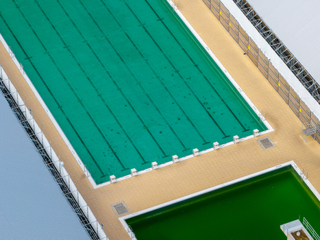 Berlin Germany 26 September 2026 Aerial view of the swimming pools at the Olympiastadion Berlin featuring vibrant green water marked lanes and surrounding paved decks.