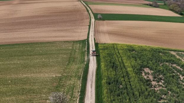 Aerial view of tractor on path between fields France.