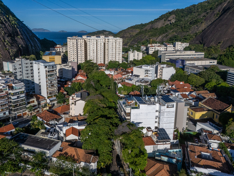 Aerial view of Urca neighborhood with dense residential housing red tiled rooftops and high rise buildings nestled between granite mountains in Rio de Janeiro Rio de Janeiro Brazil.