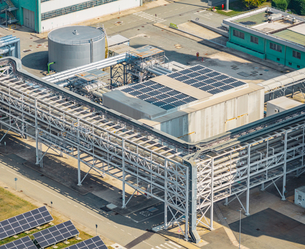 Aerial view of industrial pipe racks cooling equipment and photovoltaic solar panels at a modern power generation facility in Chivasso Piedmont Italy. Aerial view of industrial pipe racks cooling equipment and photovoltaic solar panels at a modern power generation facility in Chivasso Piedmont Italy.