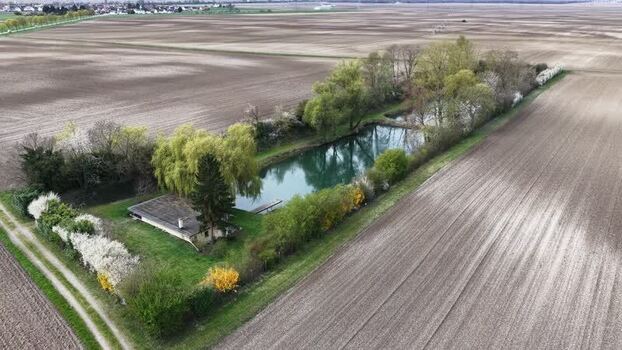 Aerial view of water pond surrounded by trees France.