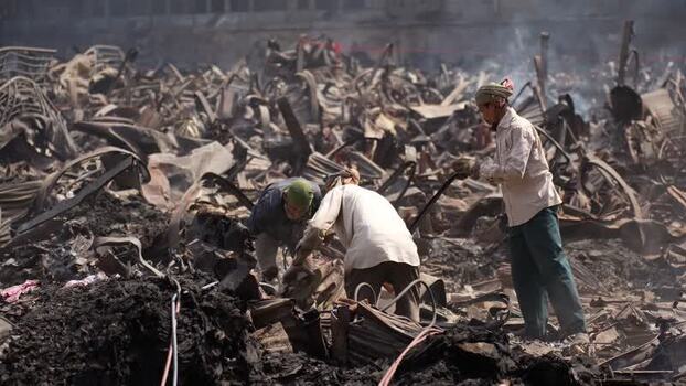 View of workers clearing twisted metal debris in Dhaka Bangladesh. View of workers clearing twisted metal debris in Dhaka Bangladesh.
