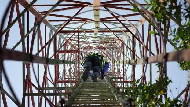 View of a technician climbing a telecommunications tower Bangladesh. View of a technician climbing a telecommunications tower Bangladesh.
