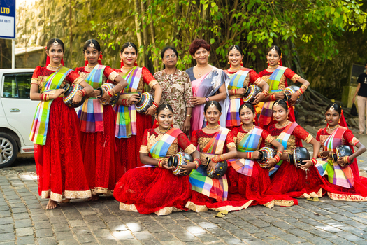 Sri Lanka 04 February 2026 View of a group of young women in traditional red costumes holding decorated pots during a cultural performance outdoors.
