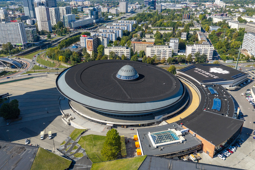 Katowice Poland 17 September 2026 Aerial view of the iconic Spodek arena featuring its distinctive circular roof and glass dome surrounded by urban buildings and green spaces.
