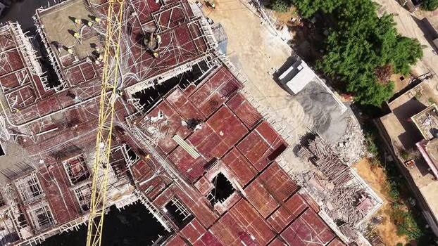Aerial view of construction site with workers in India.