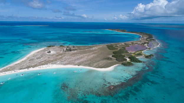 Aerial view of Los Roques archipelago with its turquoise waters white sand beaches and small boats anchored near the coral reefs in Los Roques Dependencias Federales Venezuela. Aerial view of Los Roques archipelago with its turquoise waters white sand beaches and small boats anchored near the coral reefs in Los Roques Dependencias Federales Venezuela.