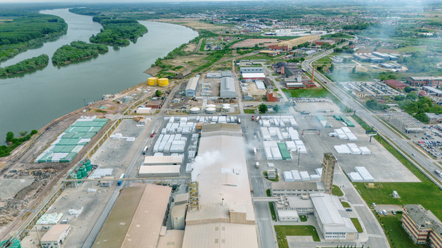 Aerial view of an industrial factory complex with large warehouses and storage yards situated along the banks of the Sava river in Sabac Vojvodina Serbia. Aerial view of an industrial factory complex with large warehouses and storage yards situated along the banks of the Sava river in Sabac Vojvodina Serbia.