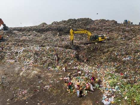 Aminbazar Bangladesh 26 January 2025 Aerial view of the Aminbazar landfill with excavators moving waste and people scavenging through piles of garbage under a hazy sky. Aminbazar Bangladesh 26 January 2025 Aerial view of the Aminbazar landfill with excavators moving waste and people scavenging through piles of garbage under a hazy sky.