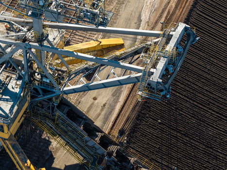 Aerial view of the massive bucket wheel excavator at Tagebau Welzow Sud brown coal open pit mine showing industrial machinery and excavated earth in Spremberg Brandenburg Germany. Aerial view of the massive bucket wheel excavator at Tagebau Welzow Sud brown coal open pit mine showing industrial machinery and excavated earth in Spremberg Brandenburg Germany.