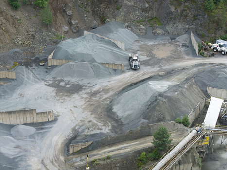 Aerial view of the porphyry and diabase mine featuring large piles of crushed stone industrial machinery and conveyor systems in Krakow Lesser Poland Poland. Aerial view of the porphyry and diabase mine featuring large piles of crushed stone industrial machinery and conveyor systems in Krakow Lesser Poland Poland.