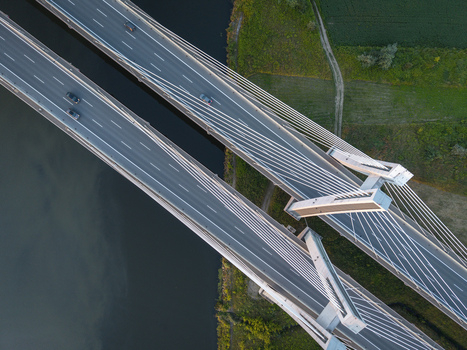 Aerial view of Most na S7 bridge over the Vistula River with cars driving on the asphalt lanes and cable stayed structure in Krakow Malopolskie Poland. Aerial view of Most na S7 bridge over the Vistula River with cars driving on the asphalt lanes and cable stayed structure in Krakow Malopolskie Poland.