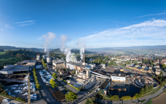 Aerial view of the Zuckerfabrik sugar factory in Aarberg with industrial buildings smoking chimneys and surrounding green landscape in Aarberg Bern Switzerland. Aerial view of the Zuckerfabrik sugar factory in Aarberg with industrial buildings smoking chimneys and surrounding green landscape in Aarberg Bern Switzerland.