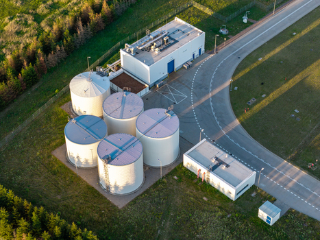 Aerial view of industrial water tanks and facility buildings surrounded by green landscape in mazowieckie Poland. Aerial view of industrial water tanks and facility buildings surrounded by green landscape in mazowieckie Poland.