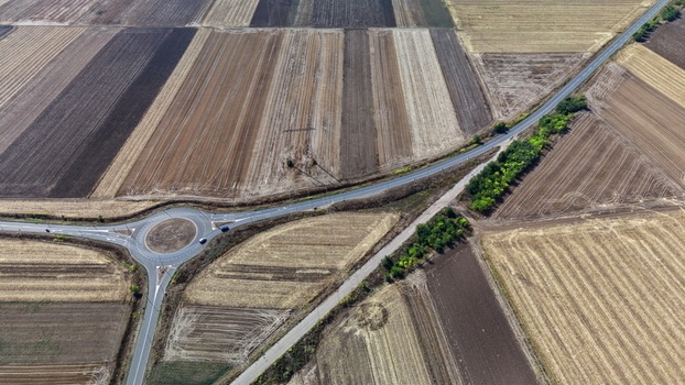 Aerial view of a roundabout surrounded by agricultural fields in the rural landscape of Bavaniste Vojvodina Serbia.