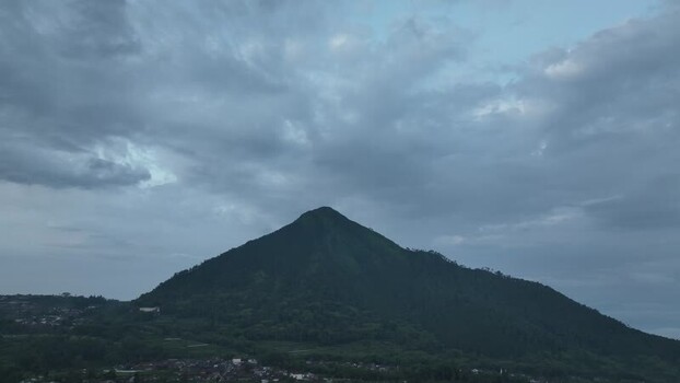 Aerial view of a conical mountain and village in Indonesia. Aerial view of a conical mountain and village in Indonesia.