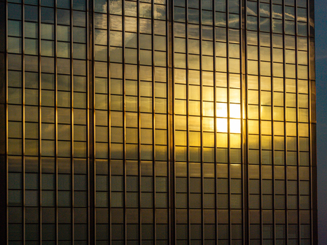 Aerial view of the glass facade of the Berlin Treptowers reflecting the golden sunset light in Berlin Berlin Germany. Aerial view of the glass facade of the Berlin Treptowers reflecting the golden sunset light in Berlin Berlin Germany.