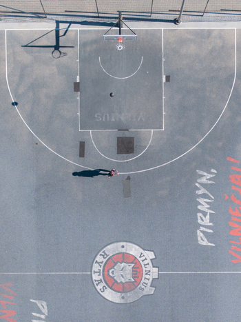 Vilnius Lithuania 20 April 2026 Aerial view of a basketball court featuring the Rytas Vilnius team logo and markings on the asphalt surface with a person standing. Vilnius Lithuania 20 April 2026 Aerial view of a basketball court featuring the Rytas Vilnius team logo and markings on the asphalt surface with a person standing.