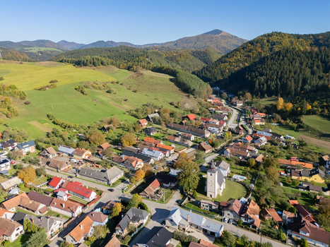 Aerial view of quaint village nestled among rolling hills and verdant forests under a clear sky Bela Dulice Zilina Region Slovakia. Aerial view of quaint village nestled among rolling hills and verdant forests under a clear sky Bela Dulice Zilina Region Slovakia.