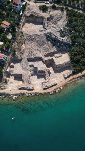 Aerial view of an excavation site on the rocky coastline with turquoise sea water and nearby houses Necujam Split Dalmatia County Croatia. Aerial view of an excavation site on the rocky coastline with turquoise sea water and nearby houses Necujam Split Dalmatia County Croatia.