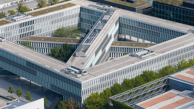 Unterfohring Germany 12 September 2026 Aerial view of the Allianz Commercial office building with its distinctive triangular architecture green roofs and surrounding trees.