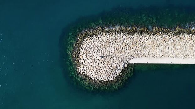 Aerial view of stone breakwater in Moraira Spain.