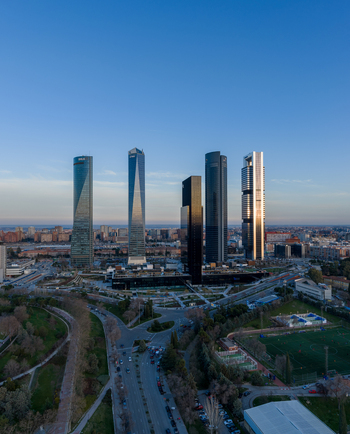 Aerial view of the Cuatro Torres Business Area with its iconic modern skyscrapers and glass facades rising above the city landscape in Madrid Comunidad de Madrid Spain. Aerial view of the Cuatro Torres Business Area with its iconic modern skyscrapers and glass facades rising above the city landscape in Madrid Comunidad de Madrid Spain.