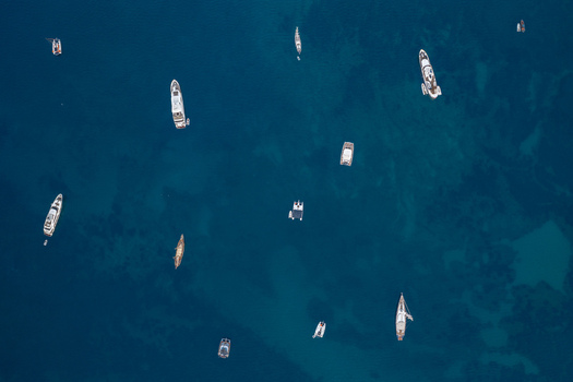 Aerial view of various yachts and boats floating on the deep blue Mediterranean Sea in Cannes Provence Alpes Cote d Azur France. Aerial view of various yachts and boats floating on the deep blue Mediterranean Sea in Cannes Provence Alpes Cote d Azur France.