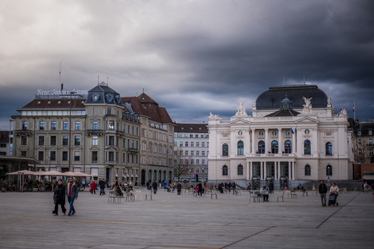Zurich Switzerland 02 April 2023 View of the expansive square where the grand facade of the Theater St. Gallen stands opposite historic buildings under a dramatic sky. Zurich Switzerland 02 April 2023 View of the expansive square where the grand facade of the Theater St. Gallen stands opposite historic buildings under a dramatic sky.