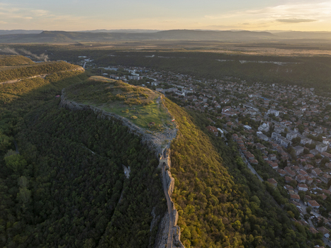 Aerial view of Ovech Fortress on a high plateau overlooking the town of Provadia surrounded by lush green hills and golden hour light in Provadia Varna Bulgaria. Aerial view of Ovech Fortress on a high plateau overlooking the town of Provadia surrounded by lush green hills and golden hour light in Provadia Varna Bulgaria.