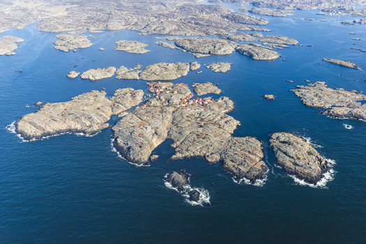 Aerial view of Flatholmen in the Bohuslan archipelago featuring small houses on rocky islands surrounded by the deep blue sea in Skarhamn Vastra Gotalands lan Sweden. Aerial view of Flatholmen in the Bohuslan archipelago featuring small houses on rocky islands surrounded by the deep blue sea in Skarhamn Vastra Gotalands lan Sweden.