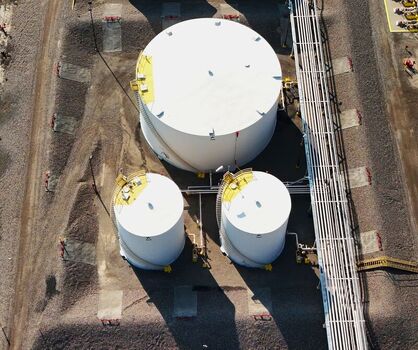 Grand Junction Colorado United States 03 July 2026 Aerial view of storage tanks at an industrial facility with white cylindrical containers metal piping and gravel ground. Grand Junction Colorado United States 03 July 2026 Aerial view of storage tanks at an industrial facility with white cylindrical containers metal piping and gravel ground.