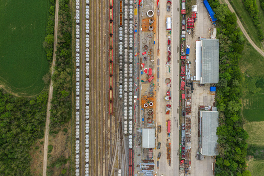 Aerial view of industrial railway tracks with freight wagons and storage facilities near green fields Mokra Horakov Jihomoravsky kraj Czechia. Aerial view of industrial railway tracks with freight wagons and storage facilities near green fields Mokra Horakov Jihomoravsky kraj Czechia.