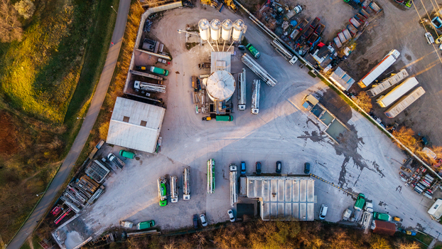Aerial view of a concrete plant casting geometric shadows amid a fleet of trucks and trailers Prague 9 Prague Czechia. Aerial view of a concrete plant casting geometric shadows amid a fleet of trucks and trailers Prague 9 Prague Czechia.