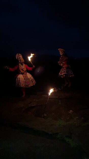 View of Kathakali dancers performing with fire torches at night India. View of Kathakali dancers performing with fire torches at night India.