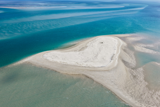 Aerial view of a heart shaped sandbank surrounded by the turquoise waters of Moreton Bay near Minjerribah North Stradbroke Island in Amity Point Queensland Australia. Aerial view of a heart shaped sandbank surrounded by the turquoise waters of Moreton Bay near Minjerribah North Stradbroke Island in Amity Point Queensland Australia.