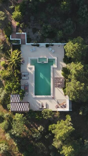 Aerial view of a swimming pool in a forest Spain.