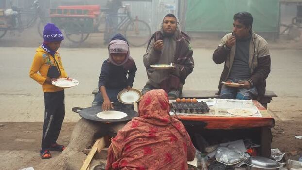 View of people eating street food in Bogura Bangladesh. View of people eating street food in Bogura Bangladesh.