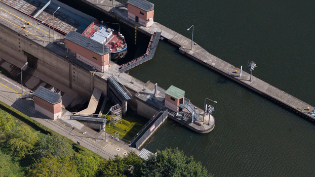 Aerial view of Neckar Staustufe und Schleuse Rockenau with a barge navigating the lock chamber on the Neckar river in Eberbach Baden Wurttemberg Germany.